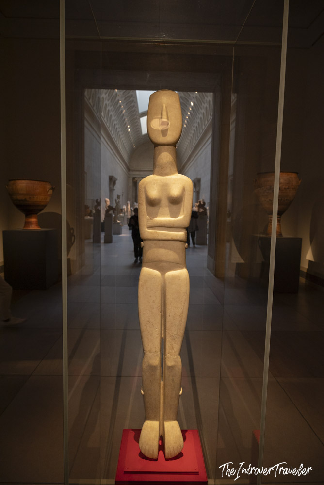 Cycladic marble figurine in a glass case at the Metropolitan Museum of Art, New York
