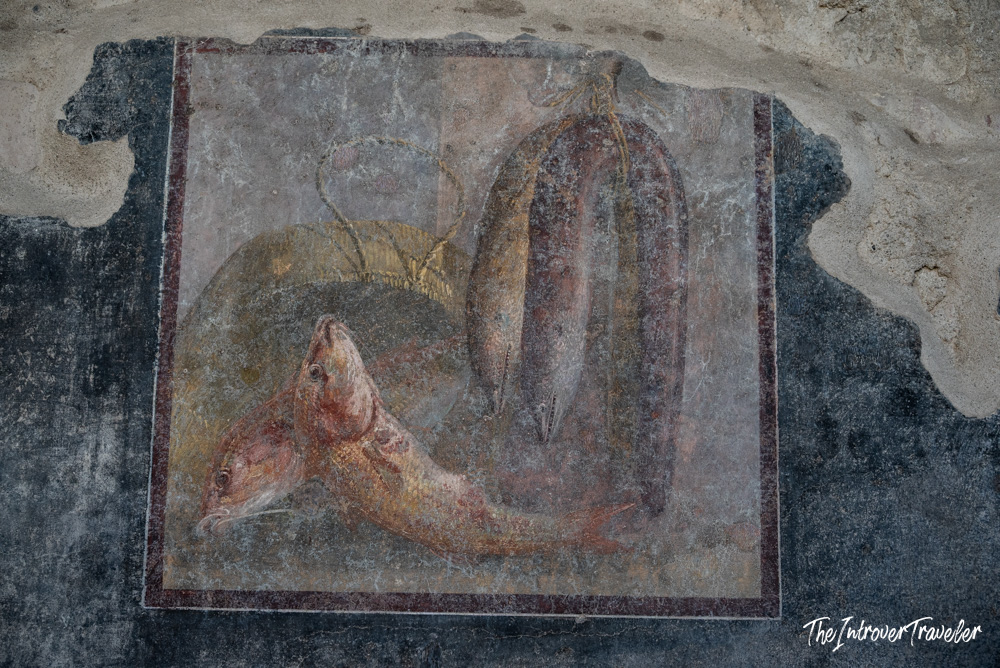 Ancient Roman still life fresco with fish and produce, preserved on a wall in Pompeii
