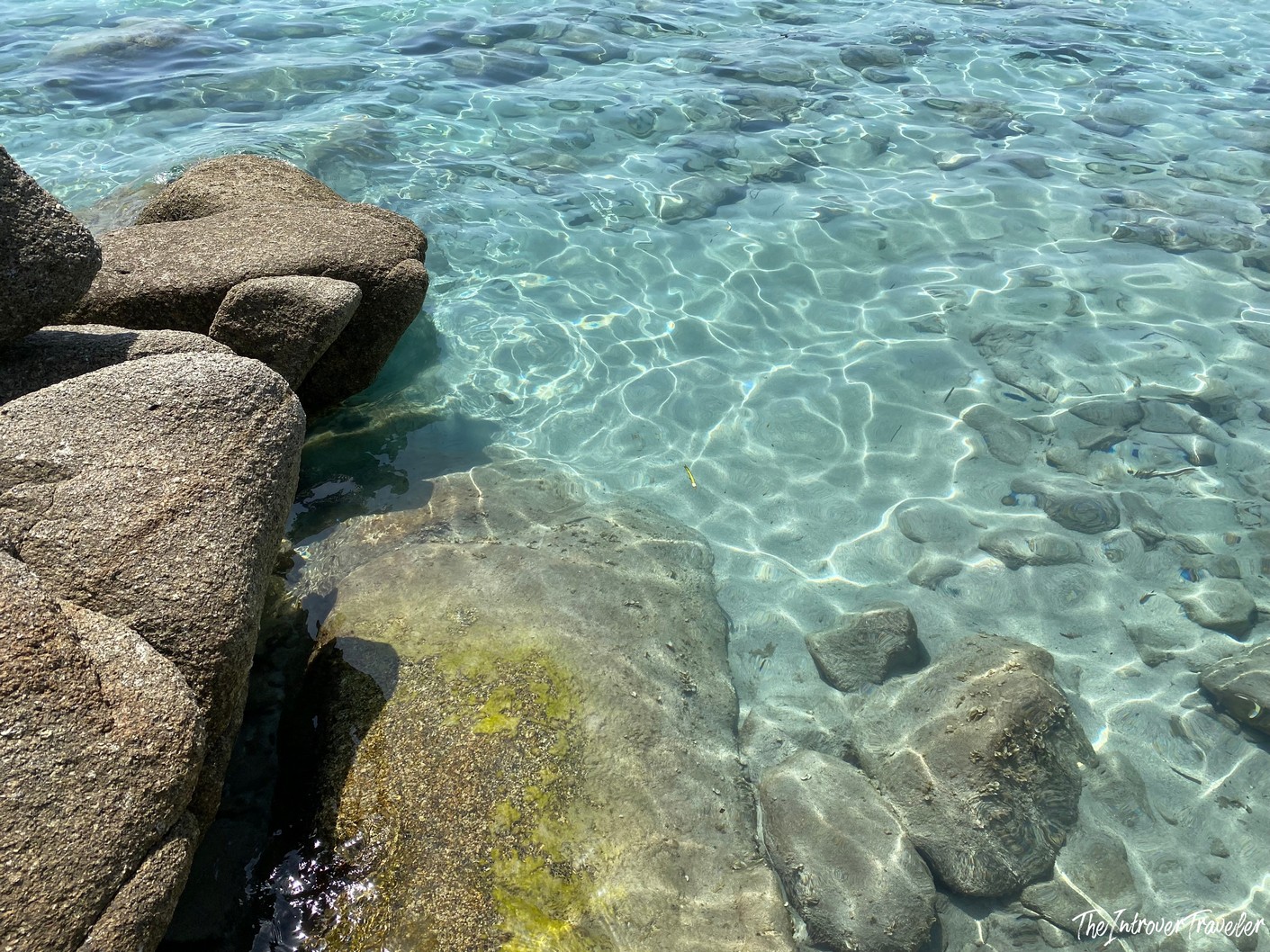 Crystal clear turquoise water over rocky seabed at Punta Molentis beach, Villasimius, Sardinia