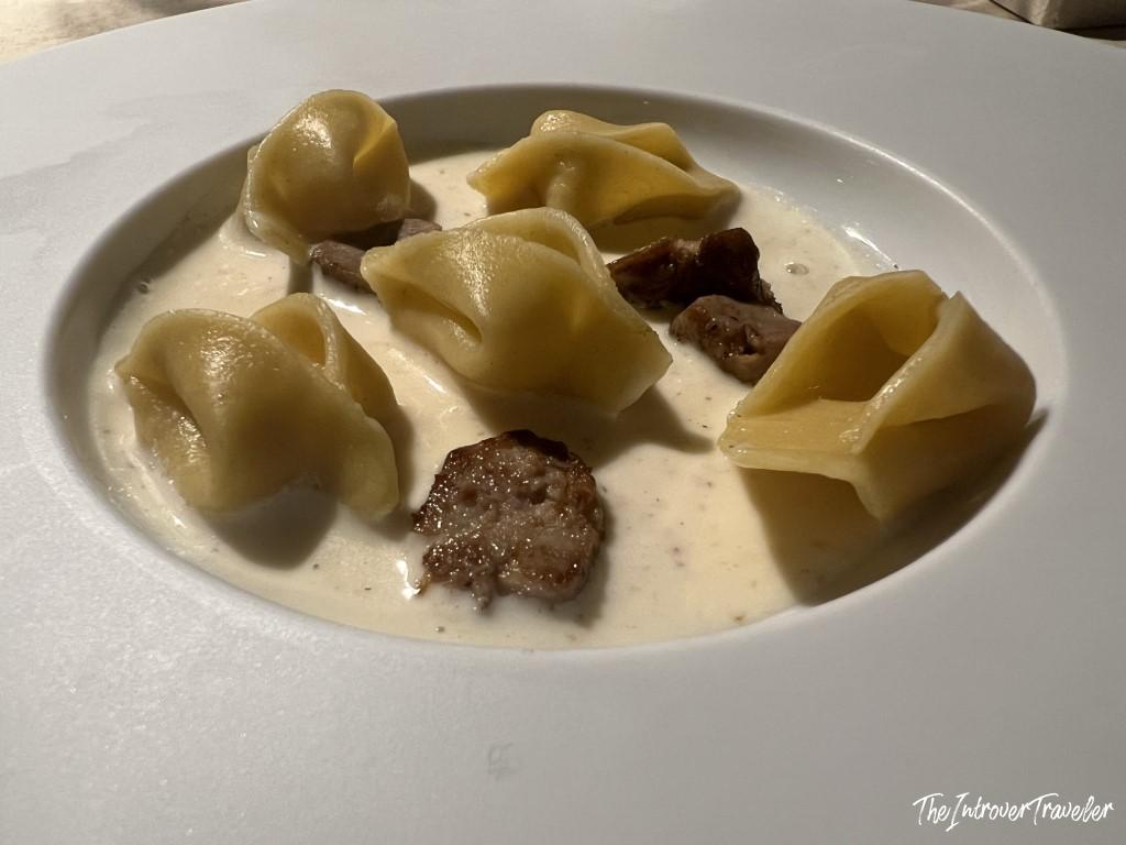 Tortellini with sausage and cream sauce, a pasta dish served at Trattoria Da Lucio in Rimini