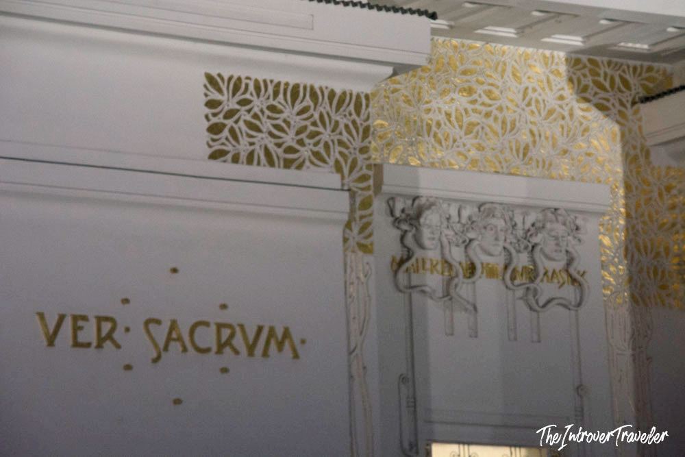 Ver Sacrum inscription with gold floral ornament and three-face relief inside the Vienna Secession Building