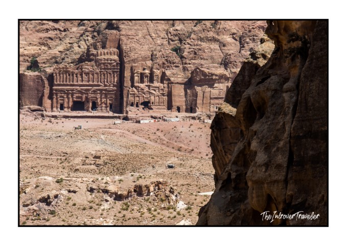 Royal Tombs of Petra carved into rose-red sandstone cliffs, seen from a distance in Jordan