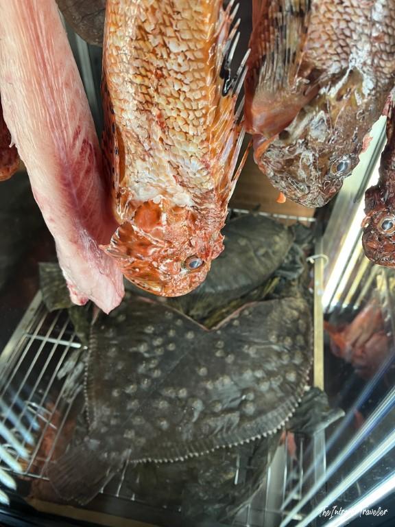 Fresh whole flatfish and red scorpionfish displayed at a Rimini seafood restaurant