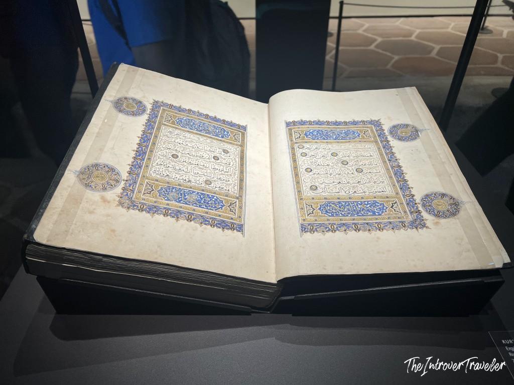 Illuminated Quran manuscript with gold and blue borders on display at Topkapi Palace, Istanbul