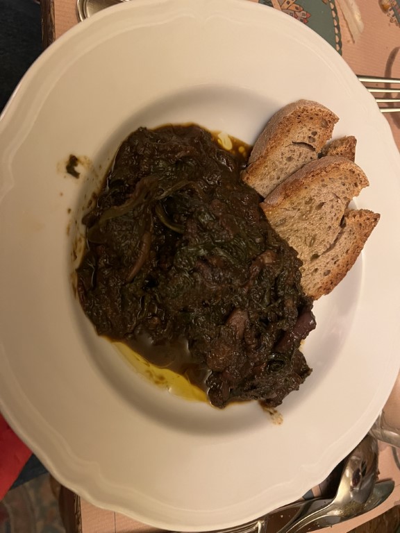 Cibrèo's signature braised greens with olive oil and toasted Tuscan bread, served at Trattoria Cibrèo in Florence