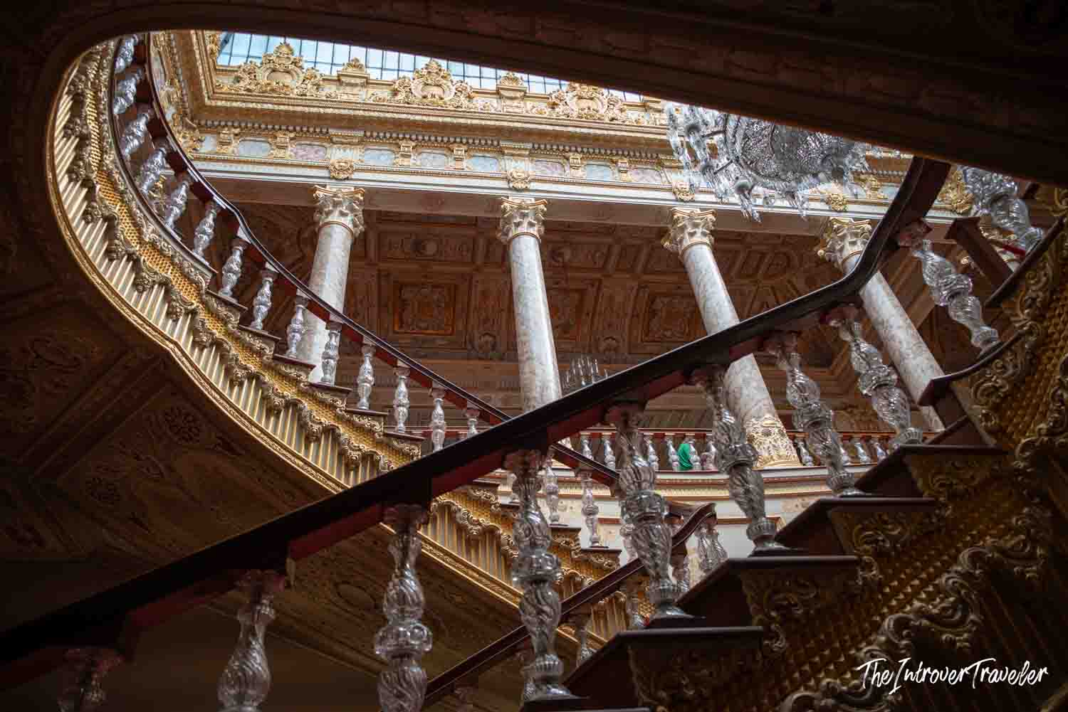 Grand ceremonial staircase at Dolmabahce Palace, with crystal banisters and gilded baroque ceilings above
