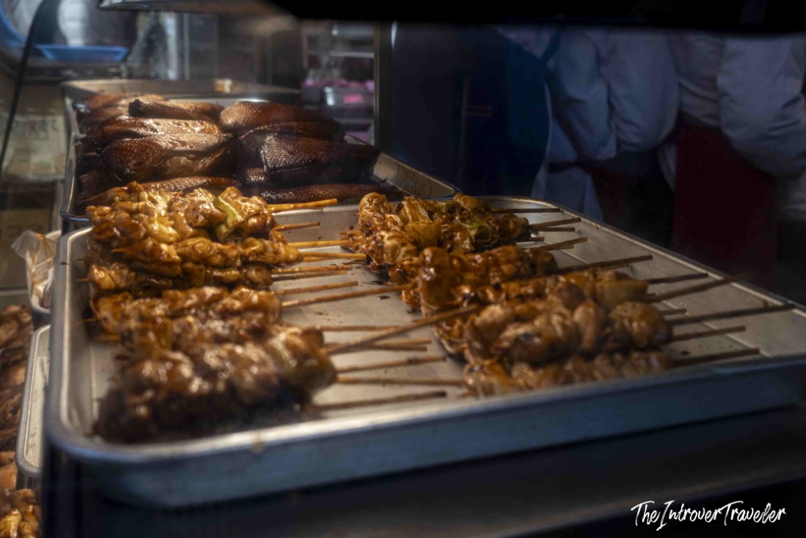 Grilled meat skewers and glazed duck at a Tsukiji market street food stall, Tokyo
