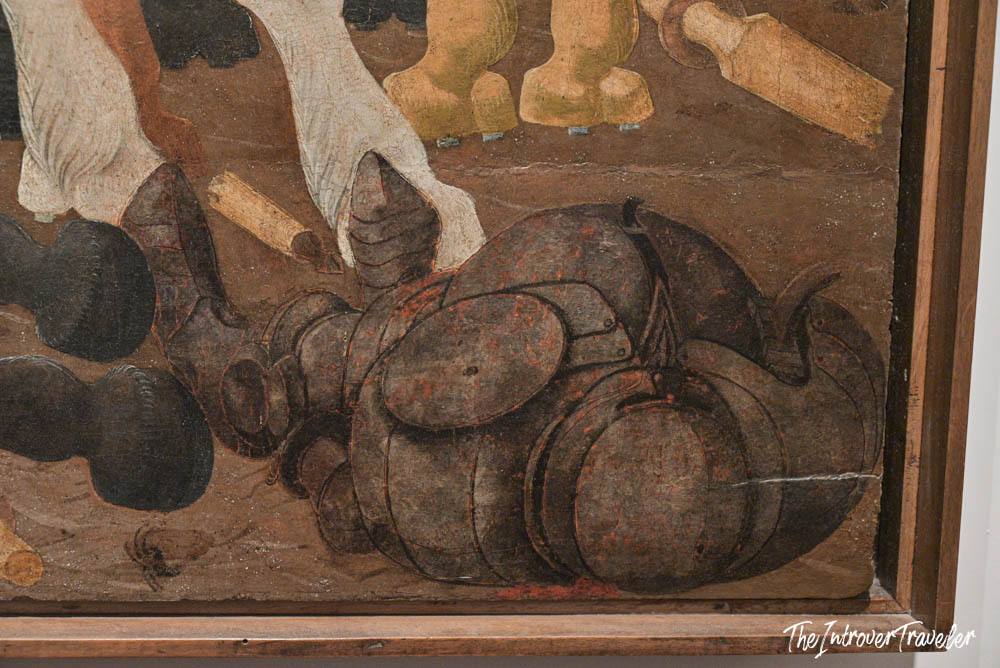 Close-up detail of scattered pots and pans in a Flemish painting at the Uffizi Gallery, Florence