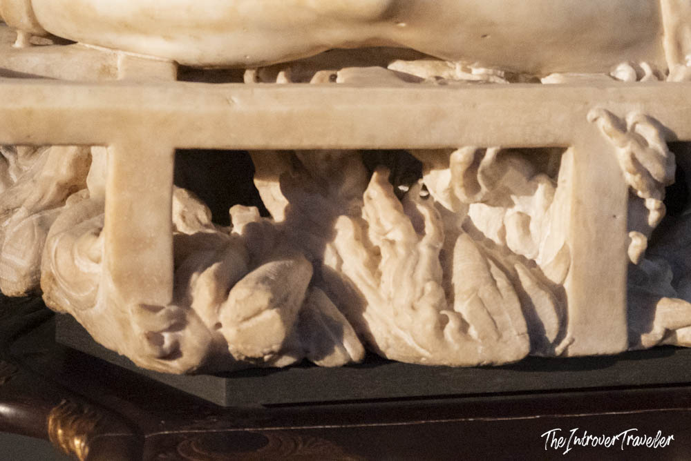 Close-up of the intricately carved marble base of Bernini's Saint Lawrence, Uffizi Gallery
