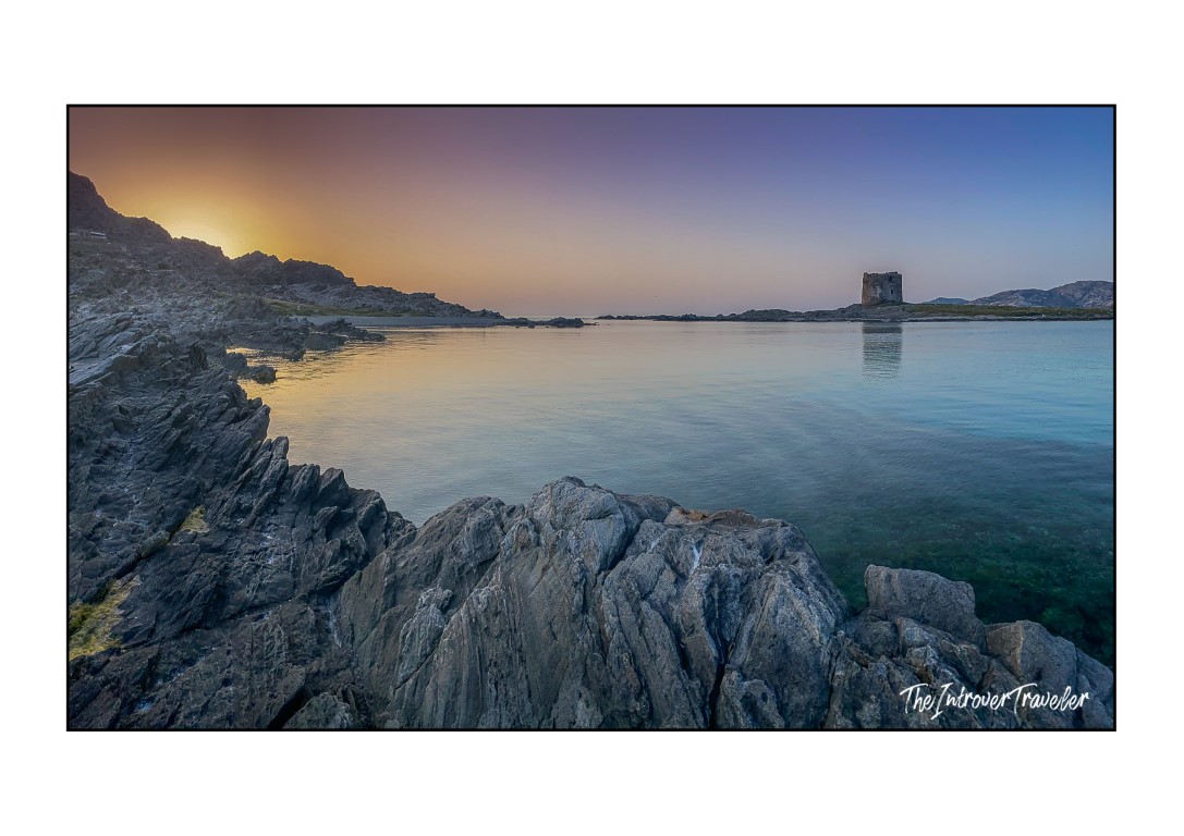 Sunset at La Pelosa Beach, Stintino, with Torre della Pelosa and turquoise waters