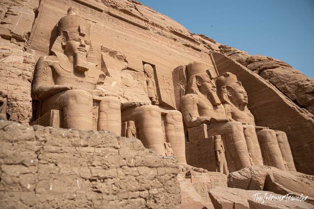 Four colossal seated statues of Ramesses II carved into the sandstone facade of Abu Simbel temple, Egypt