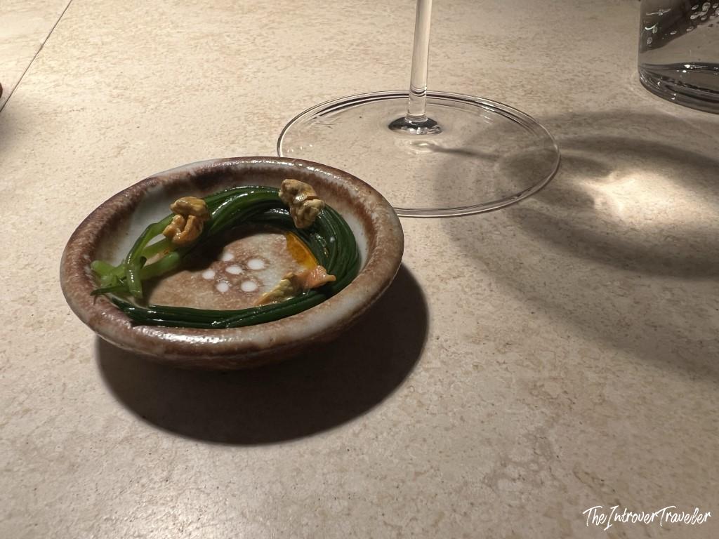 Elegant seafood course in handmade ceramic bowl at Trattoria Da Lucio, Rimini fine dining