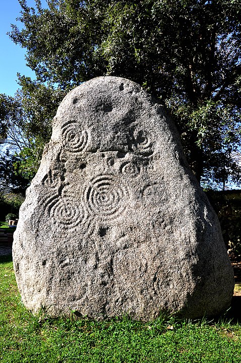 Prehistoric menhir with concentric circle carvings linked to the Mont'e Prama archaeological site in Sardinia
