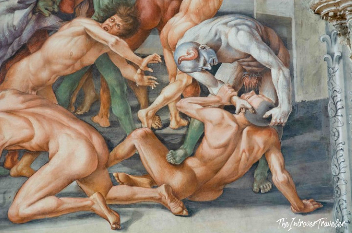 Sistine Chapel fresco detail showing demons dragging sinners, from Michelangelo's Last Judgment scene