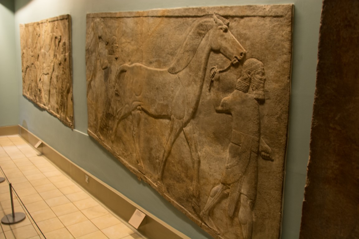 Assyrian stone relief of a groom leading a horse, British Museum London