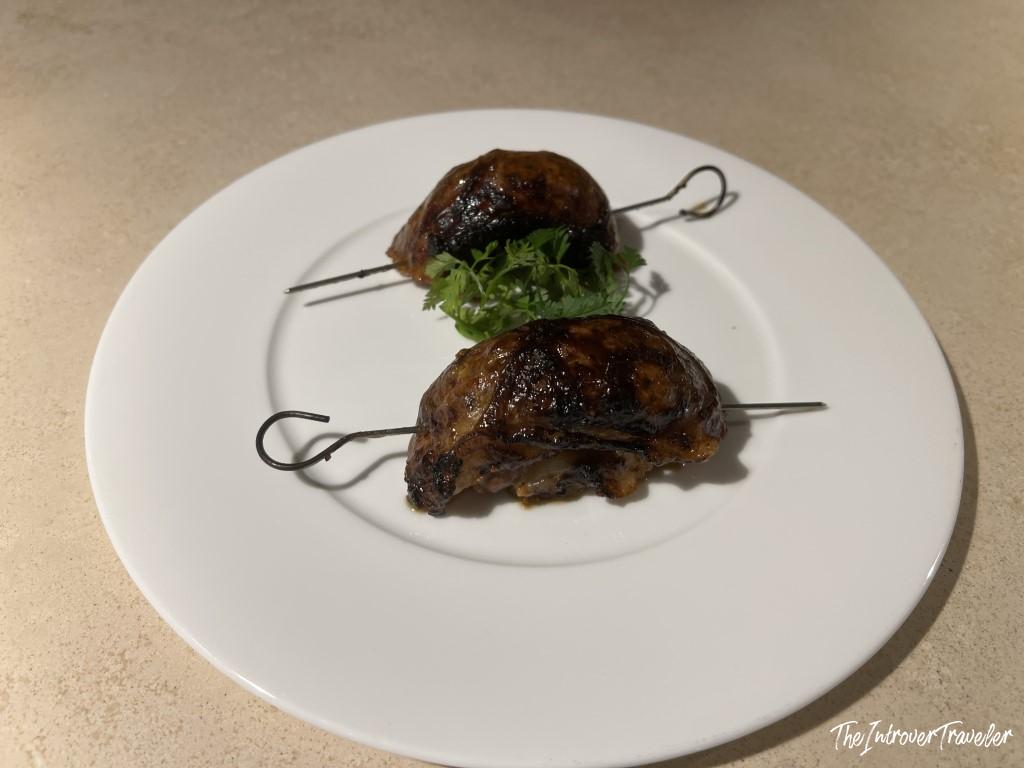 Two glazed seafood skewers with marine nduja filling, served at Trattoria Da Lucio in Rimini