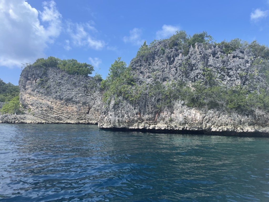 Jagged limestone karst islands rising from turquoise waters in Raja Ampat, Indonesia