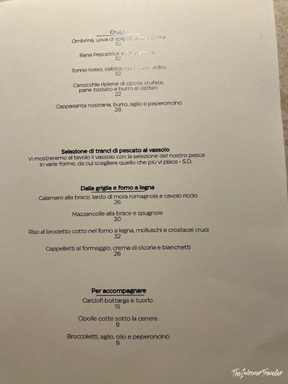 Italian seafood menu at Trattoria Da Lucio in Rimini, featuring grilled fish and pasta dishes