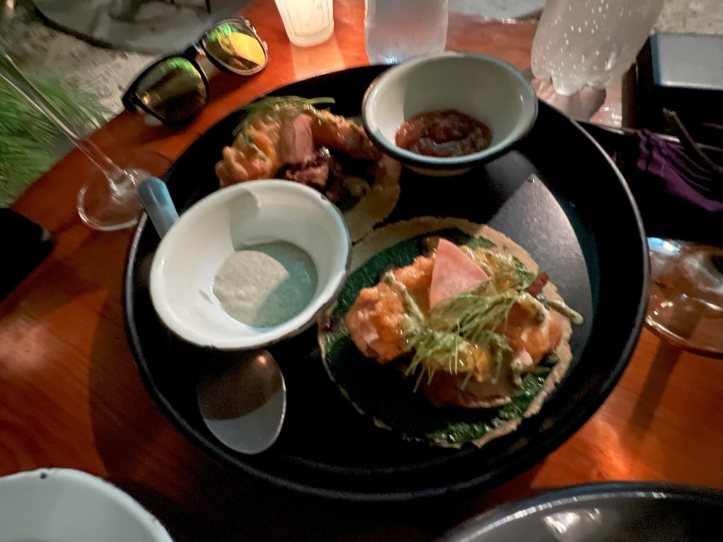Kondesa Cozumel tasting plate with shrimp, salmon tostada, dipping sauces, and tres leches dessert