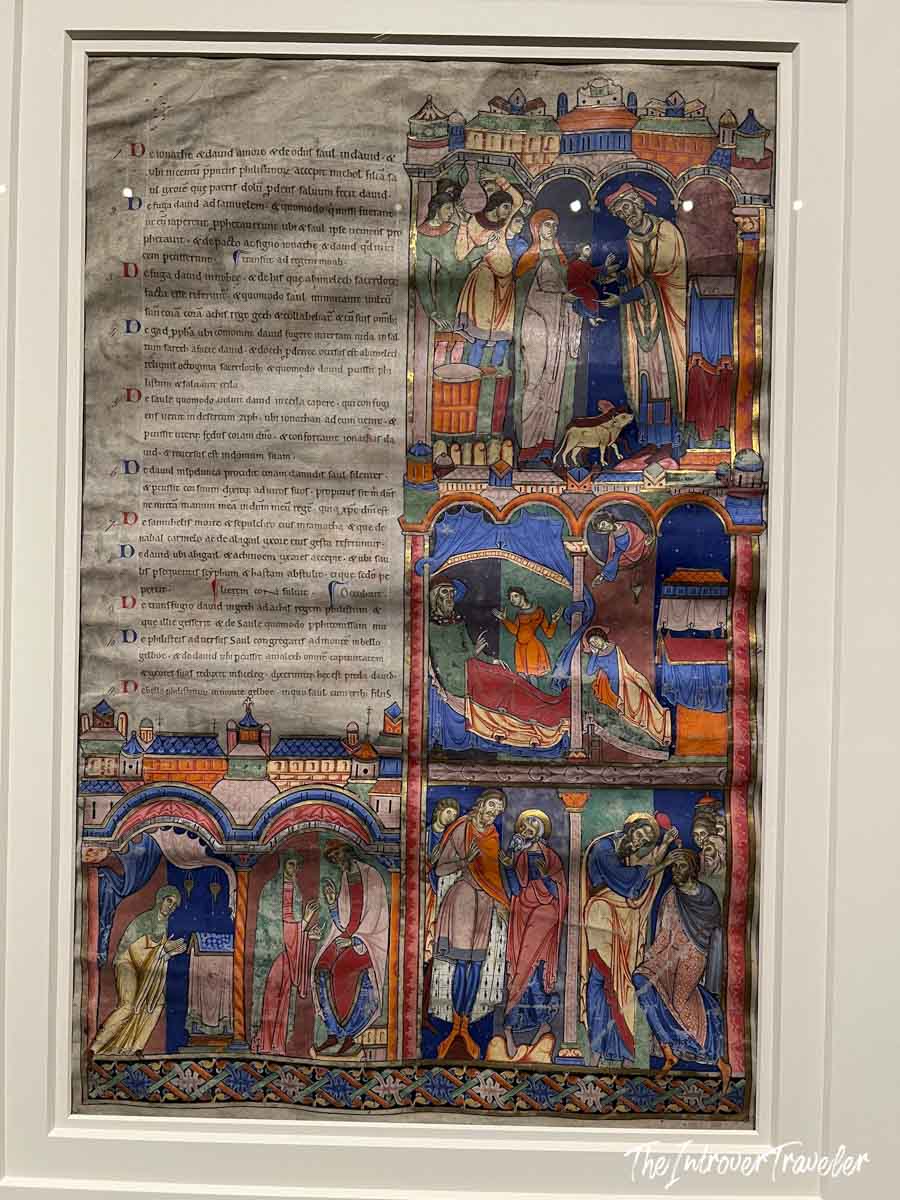 Illuminated medieval manuscript page with Latin text and vivid biblical scenes, Morgan Library New York