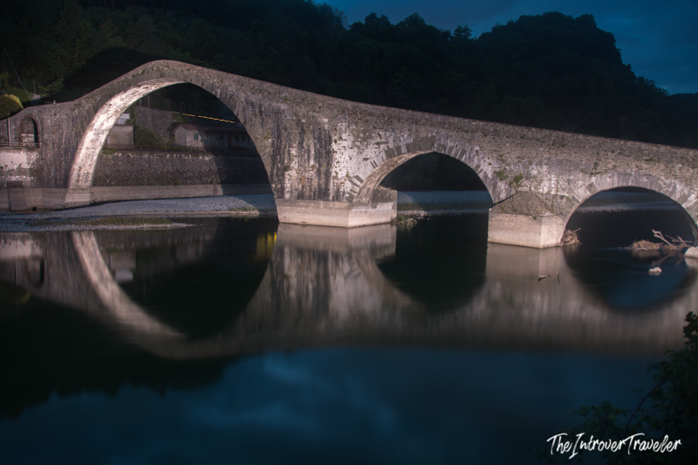 Ponte della Maddalena (Devil's Bridge) in Borgo a Mozzano reflected at dusk