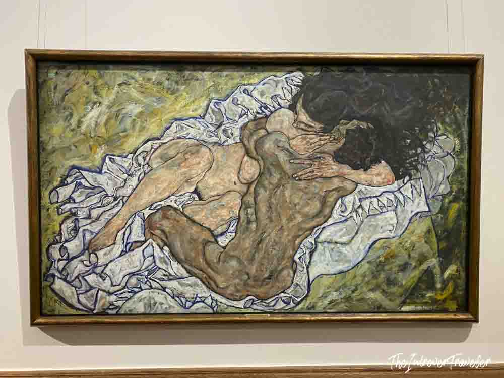 The Embrace by Egon Schiele, expressionist oil painting on display at the Belvedere Museum Vienna