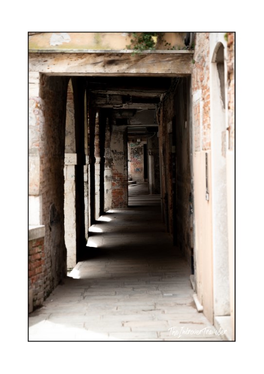 Narrow covered passageway with exposed brick arches in Venice, near Le Antiche Carampane