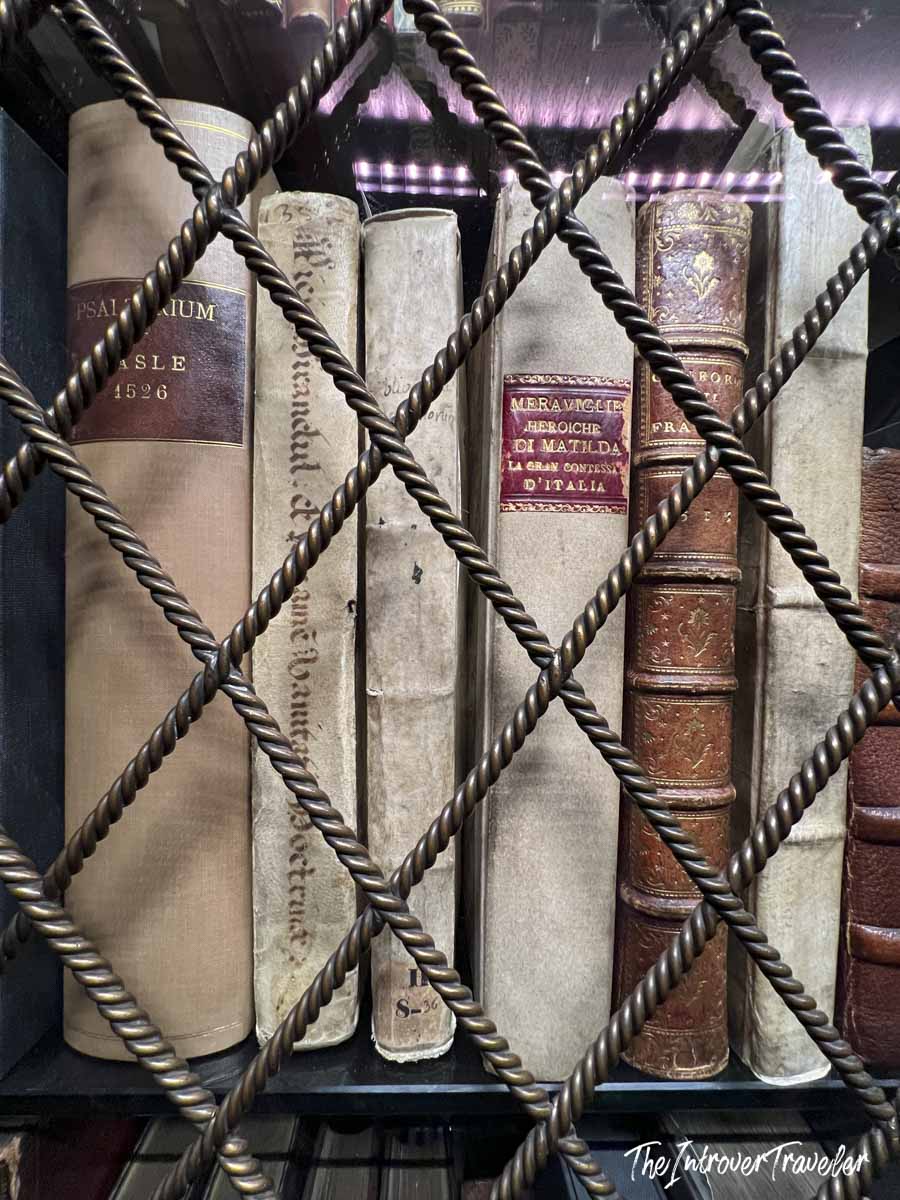 Rare books behind decorative iron lattice at the Morgan Library, including a 1526 Psalterium