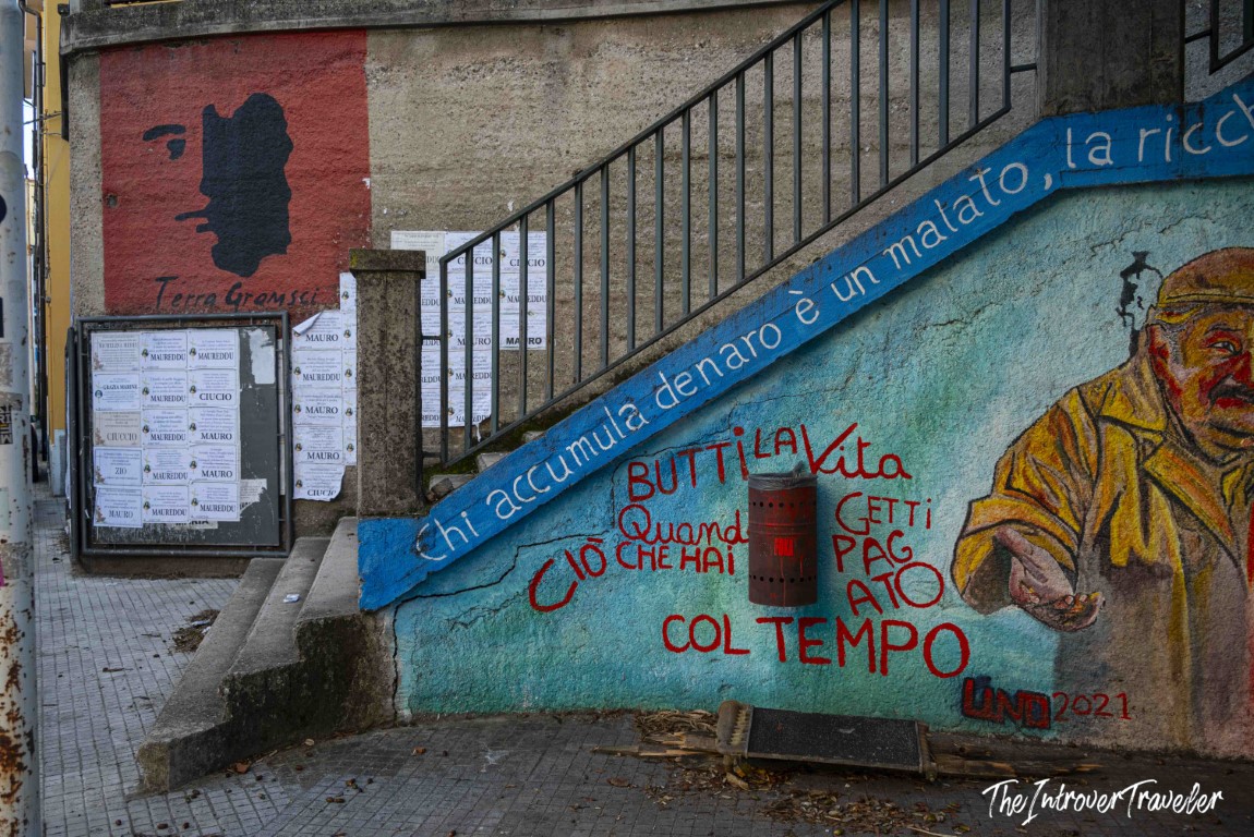 Orgosolo mural with Gramsci silhouette and Italian political quote on staircase wall, Sardinia