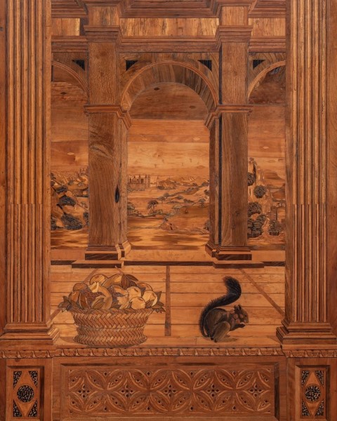 Intarsia panel in Federico da Montefeltro's Studiolo, showing columns, landscape, fruit basket, and squirrel