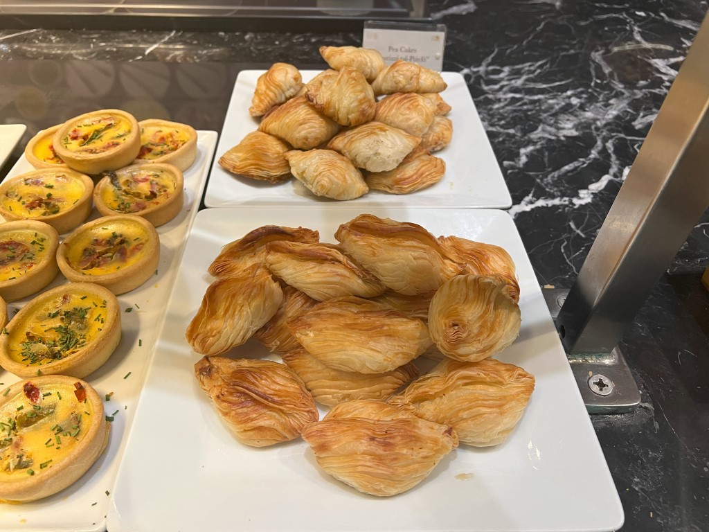 Flaky pastries and mini quiches on display at the La Valette Lounge food buffet, Malta Airport