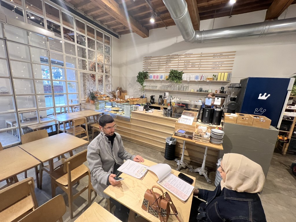 Two guests reviewing the menu at Melaleuca Bistrot, a bright modern cafe in Florence