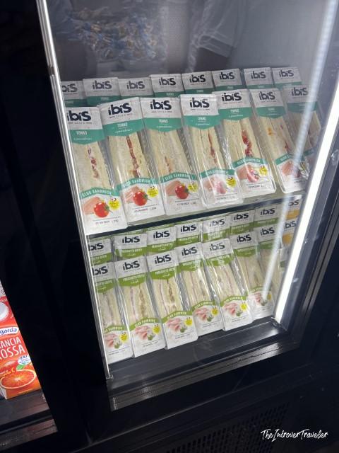 Fridge display of ibis-branded packaged sandwiches, the only food offering at Prima Vista Lounge Cagliari