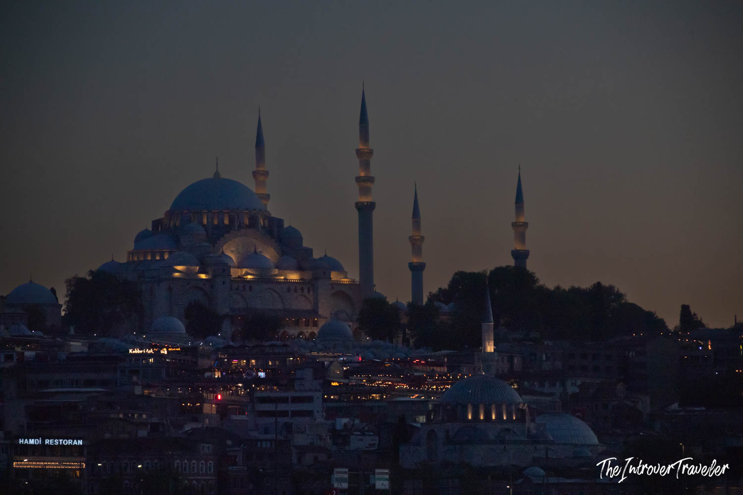 Süleymaniye Mosque illuminated at dusk, dominating the Istanbul skyline with its dome and four minarets