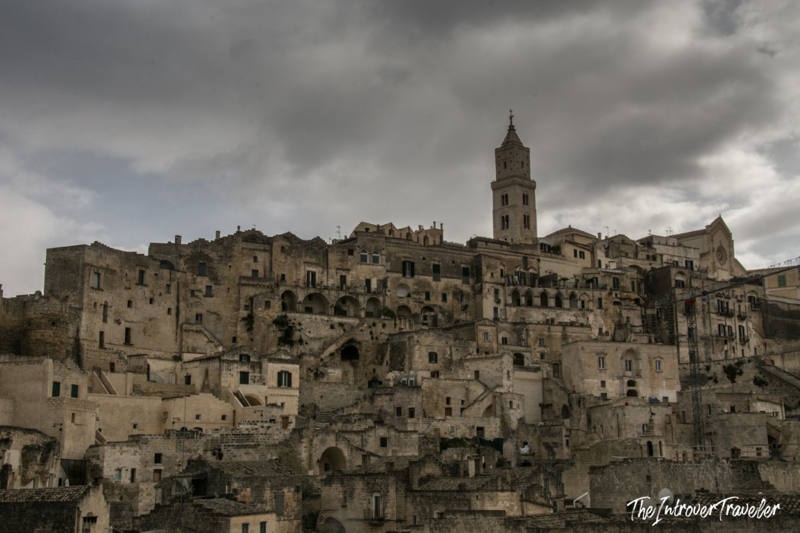 Dramatic skyline of Matera's Sassi district with the Cathedral bell tower rising above ancient cave dwellings