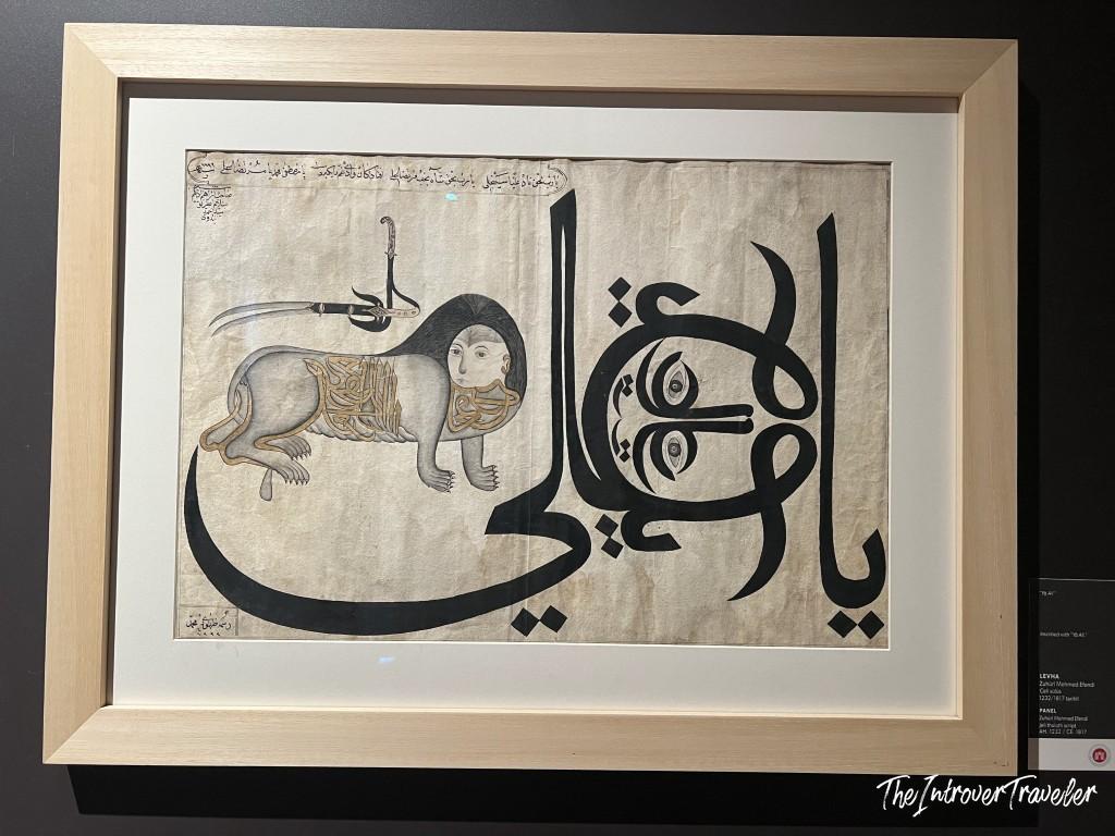 Framed Ottoman calligraphy panel with a lion figure, displayed at Topkapi Palace Istanbul