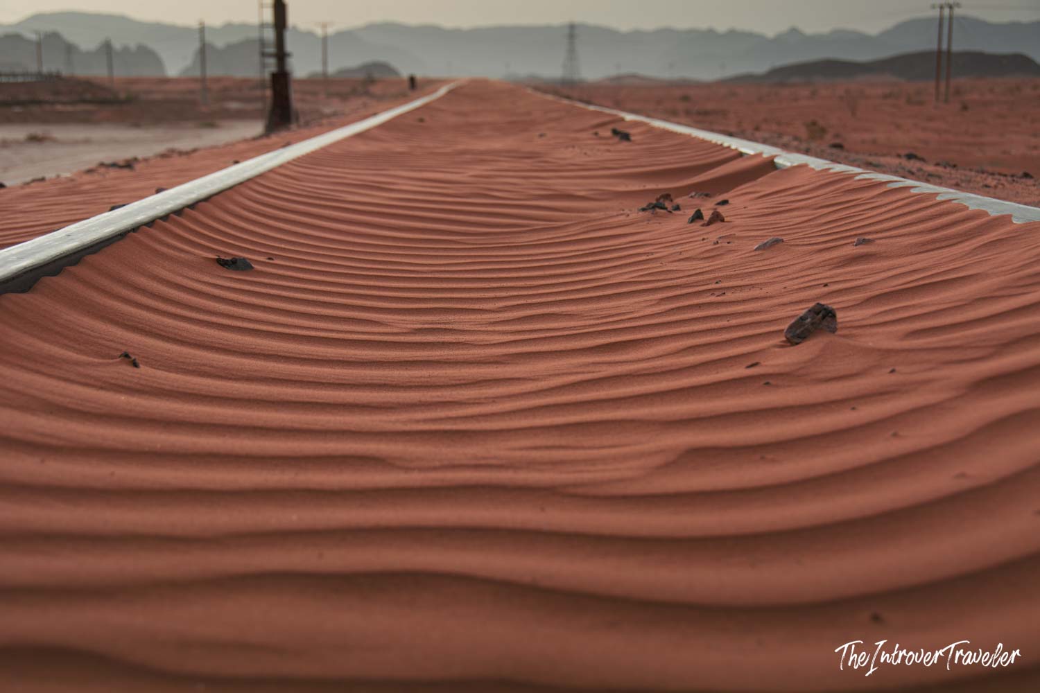 Red sand dunes burying old Hejaz Railway tracks in Wadi Rum desert, Jordan