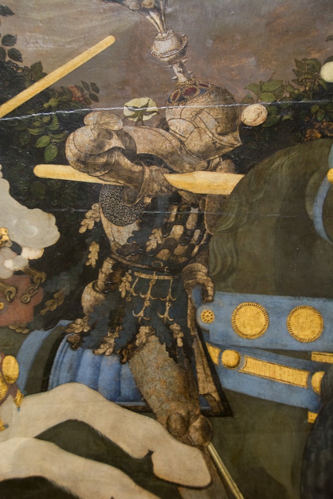 Close-up detail of an armored knight on horseback in a Renaissance painting at the National Gallery London
