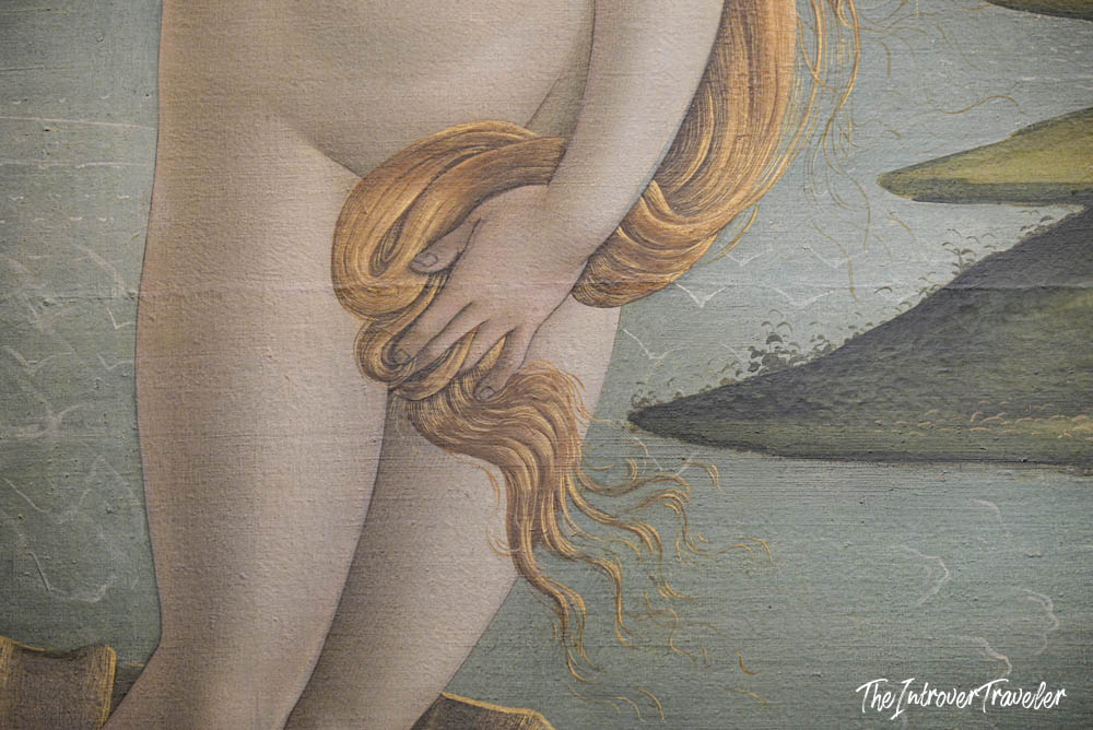 Close-up detail of Botticelli's Birth of Venus, showing Venus holding her golden hair, Uffizi Gallery Florence