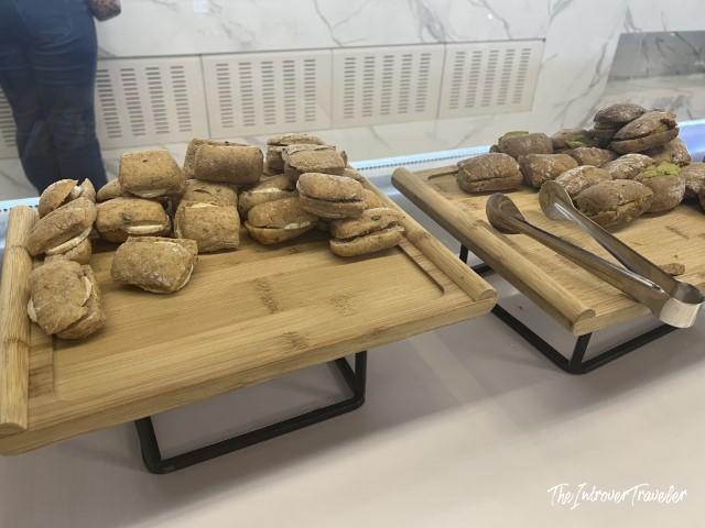 Filled bread rolls on wooden boards at the Pau Casals Lounge food buffet, Barcelona El Prat Airport