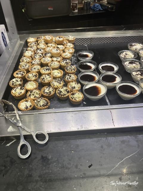 Mini pastry tarts and panna cotta cups in the Plaza Premium Lounge dessert spread at Rome Fiumicino airport