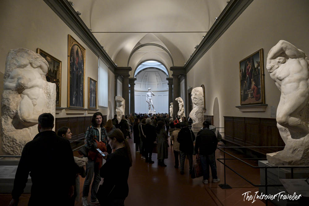 Galleria dell'Accademia nave lined with Prisoners statues, Michelangelo's David visible at the far end
