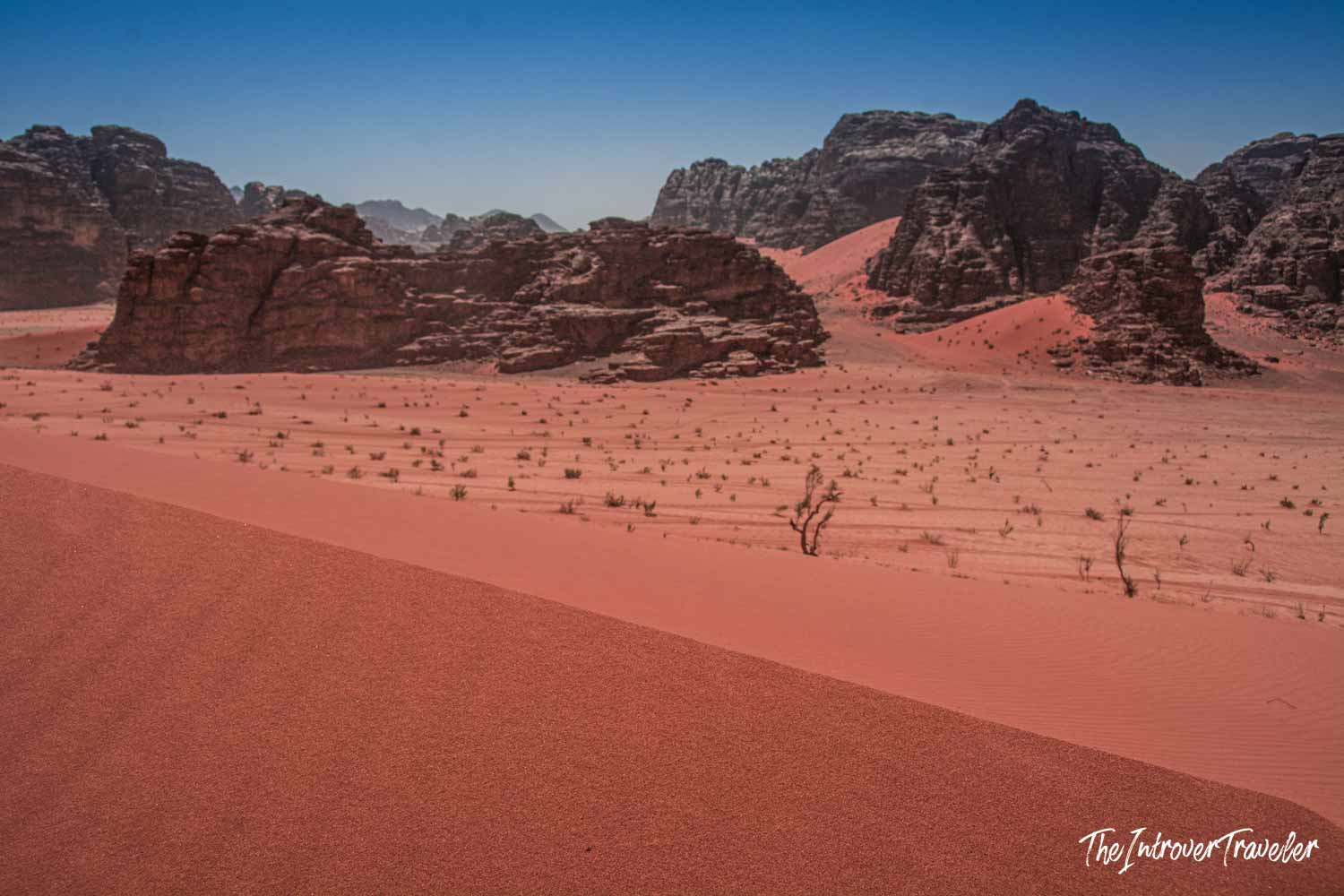Vast red sand dunes and sandstone rock formations in Wadi Rum desert, Jordan