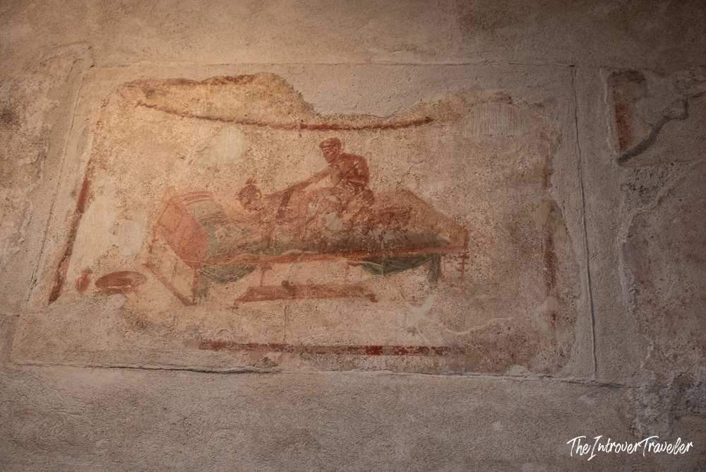 Erotic fresco on the wall of the Lupanar brothel in ancient Pompeii