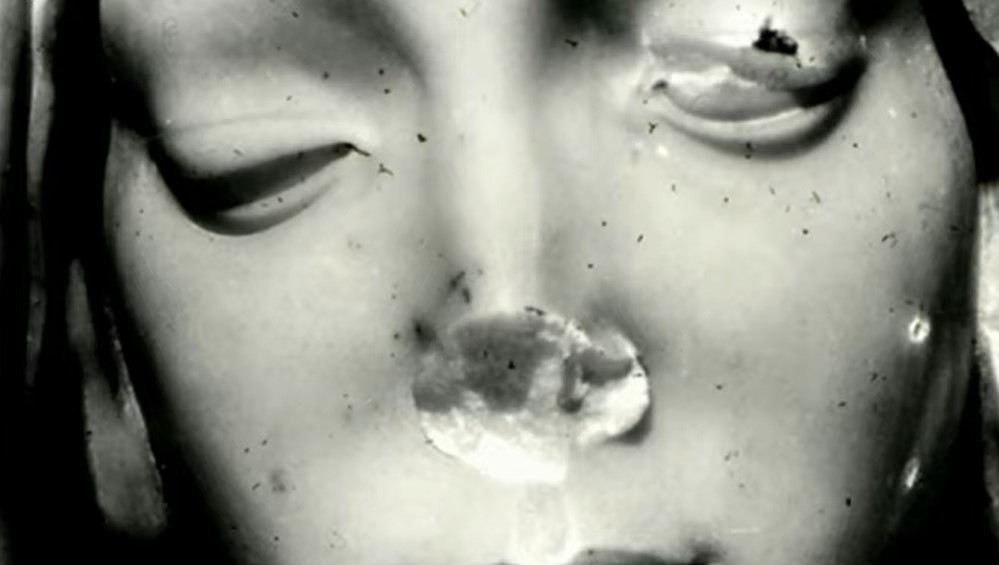 Close-up of Michelangelo's Pietà face, showing damage from the 1972 hammer attack on the Virgin Mary statue.