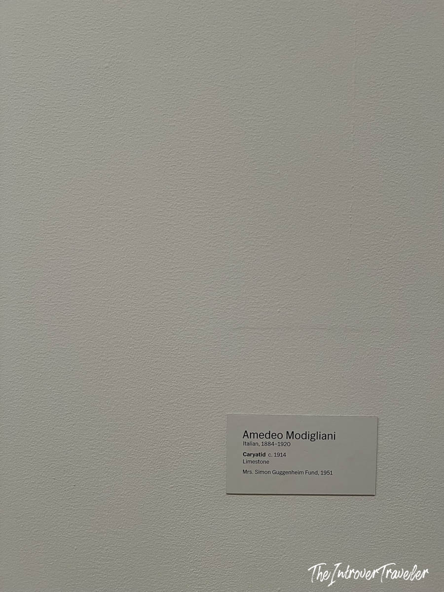 Museum wall label for Caryatid (c. 1914), a limestone sculpture by Amedeo Modigliani at MoMA New York