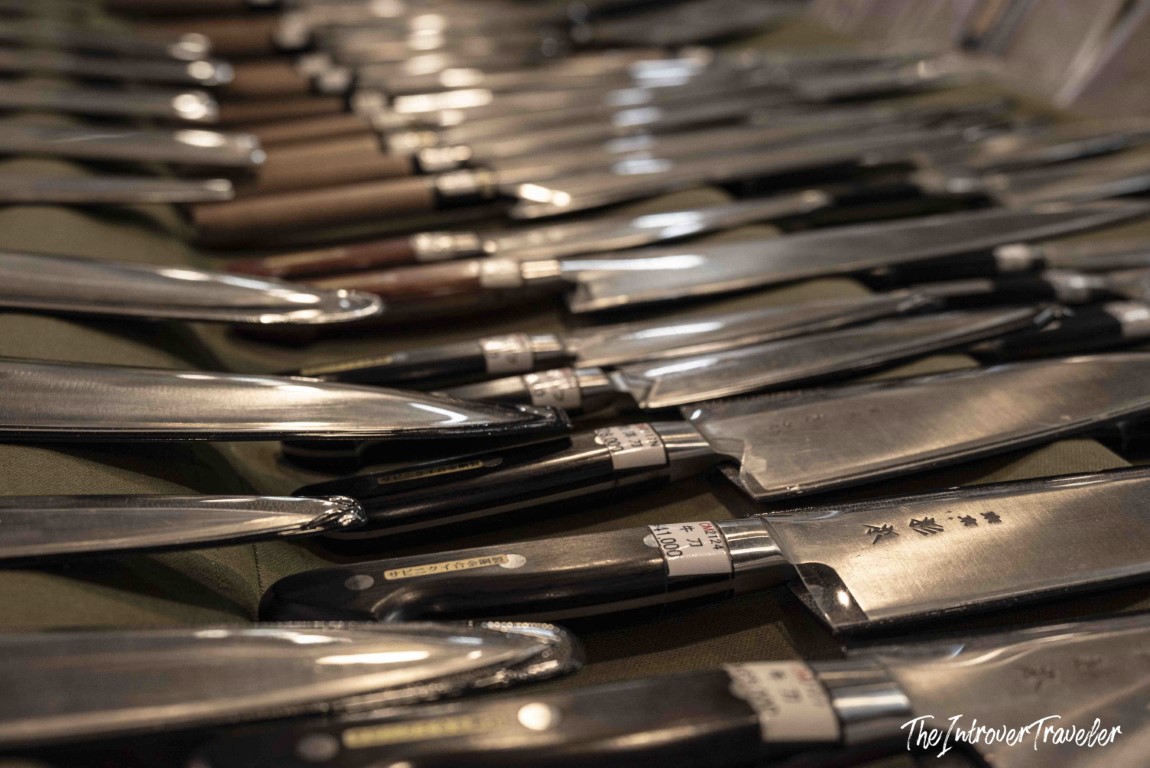 Rows of traditional Japanese kitchen knives with price tags displayed at Tsukiji market, Tokyo