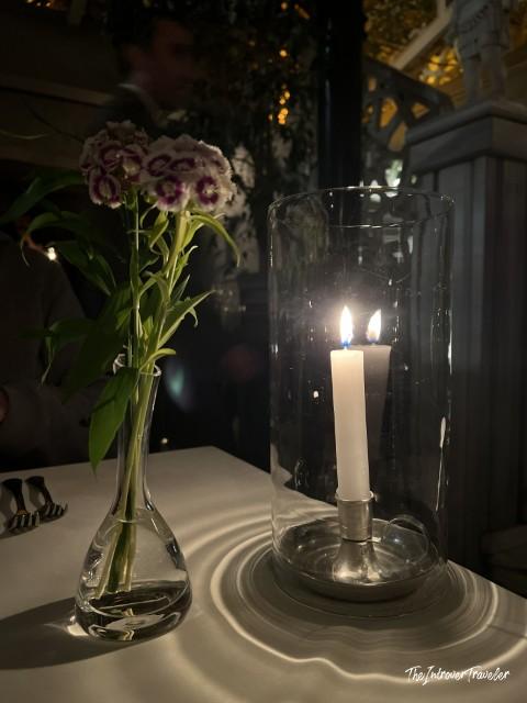 Candlelit table setting at Lokanta 1741 Istanbul, with fresh flowers and glowing hurricane candle holder