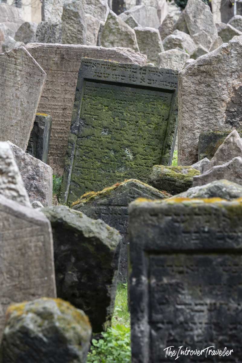 Moss-covered Hebrew tombstones crowded together at the Old Jewish Cemetery in Prague's Josefov quarter