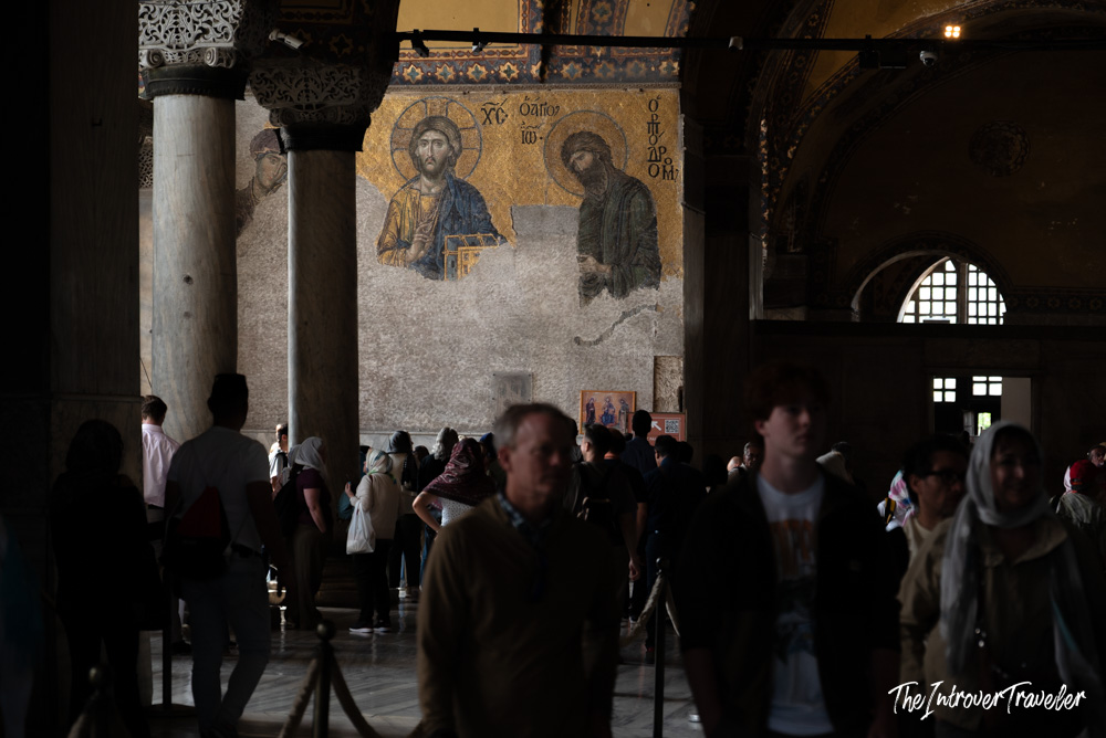 Deesis mosaic in Hagia Sophia, Istanbul, showing Christ flanked by figures amid crowds of visitors